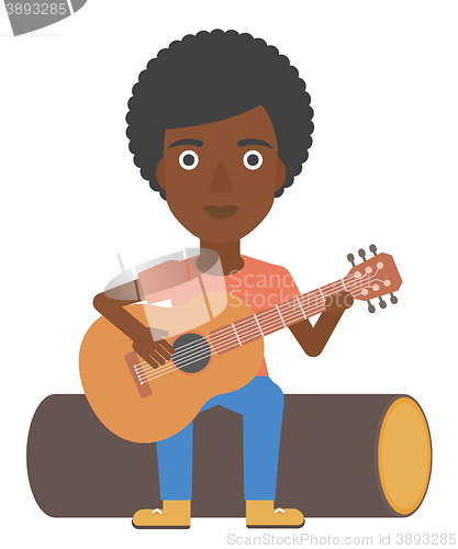 Image of Woman playing guitar.