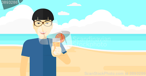 Image of Tourist with cocktail on the beach.