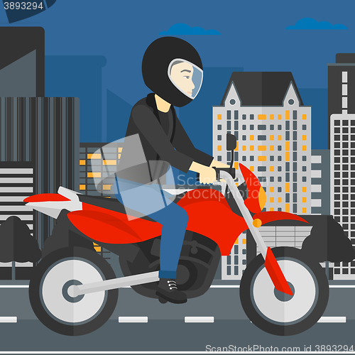 Image of Man riding motorcycle.