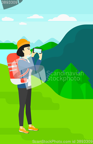 Image of Backpacker taking photo.