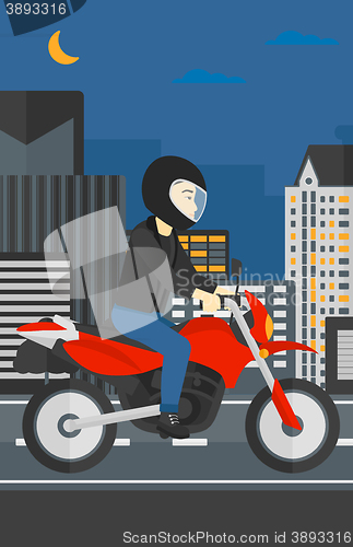 Image of Man riding motorcycle.