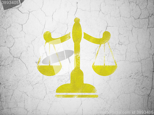 Image of Law concept: Scales on wall background