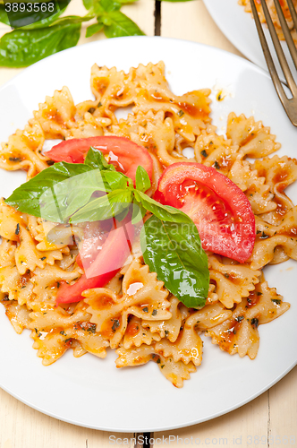 Image of Italian pasta farfalle butterfly bow-tie and tomato sauce