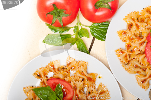 Image of Italian pasta farfalle butterfly bow-tie and tomato sauce