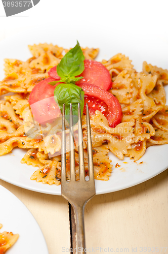 Image of Italian pasta farfalle butterfly bow-tie and tomato sauce