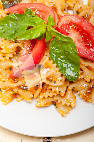 Image of Italian pasta farfalle butterfly bow-tie and tomato sauce