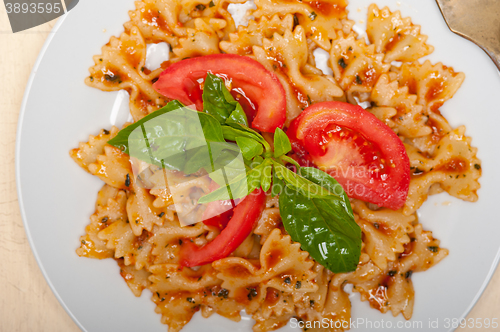 Image of Italian pasta farfalle butterfly bow-tie and tomato sauce