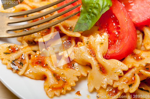 Image of Italian pasta farfalle butterfly bow-tie and tomato sauce