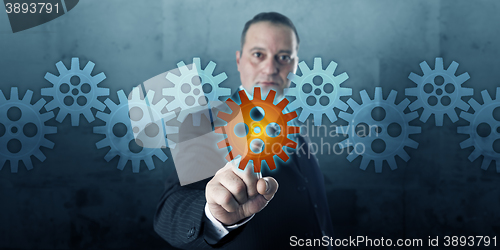 Image of Entrepreneur Selecting A Cog In A Gear Train