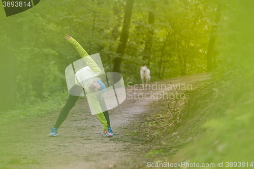 Image of Sporty woman  working out in forest. 