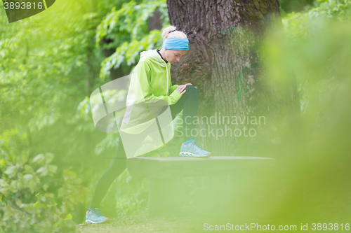 Image of Sporty woman  working out in forest. 