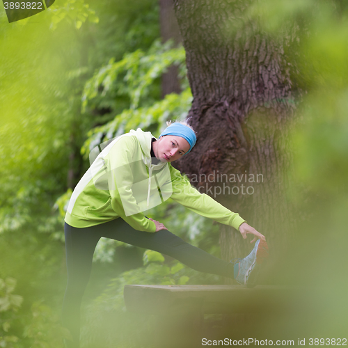 Image of Sporty woman  working out in forest. 