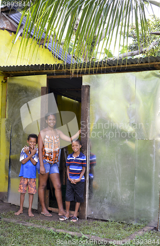 Image of editorial lady and boys zinc sheet metal house Big Corn Island N