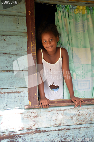 Image of native Nicaraguan girl smiling  clapboard house Big Corn Island 
