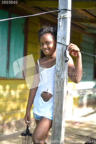 Image of native Nicaraguan girl smiling  clapboard house Big Corn Island 
