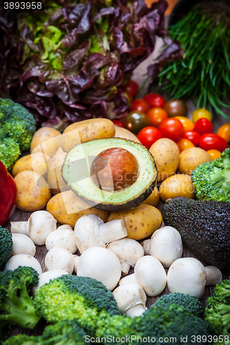 Image of Assorted raw vegetables on wooden background