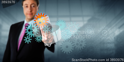 Image of Businessman Touching Cog In A Virtual Gear Train