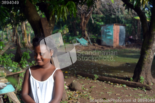 Image of native Nicaraguan girl smiling  clapboard house Big Corn Island 