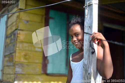 Image of native Nicaraguan girl smiling  clapboard house Big Corn Island 