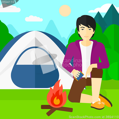 Image of Man kindling fire.