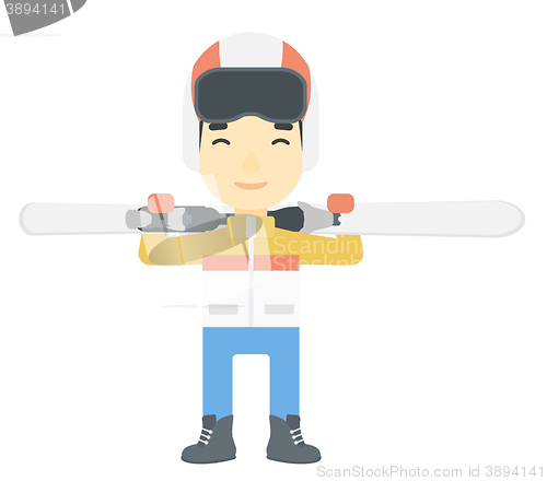 Image of Man holding skis.