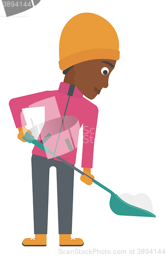 Image of Woman shoveling and removing snow.
