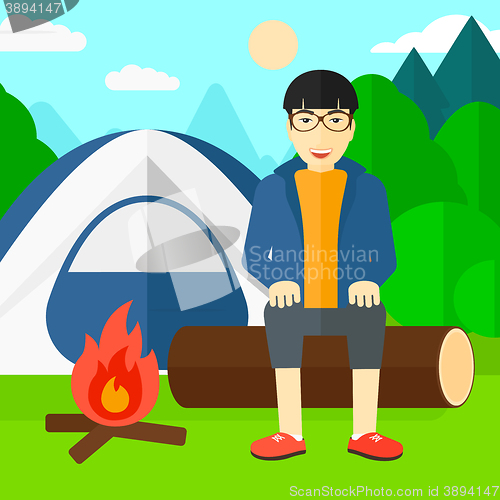 Image of Man sitting at camp.