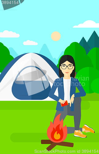 Image of Woman kindling fire.