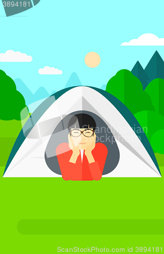 Image of Man lying in tent.