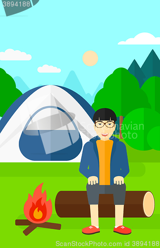 Image of Man sitting at camp.