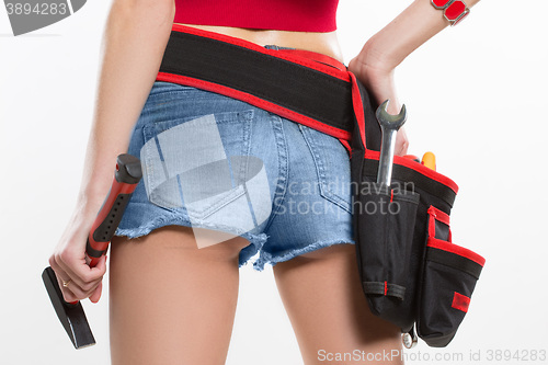 Image of girl holding a hammer next to the booty.