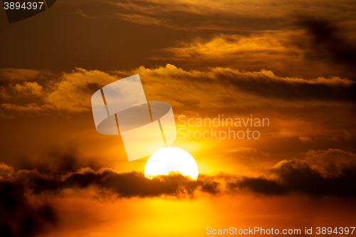 Image of sunset with sun clouds over clouds