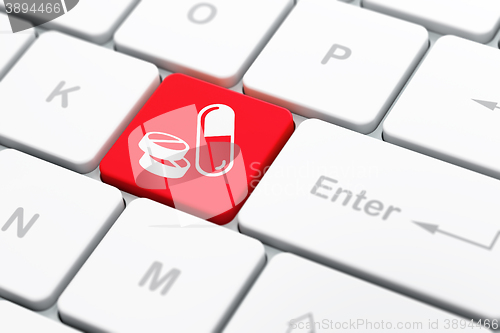 Image of Healthcare concept: Pills on computer keyboard background