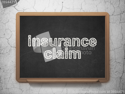 Image of Insurance concept: Insurance Claim on chalkboard background