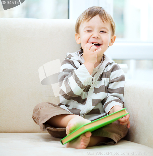 Image of Little boy is reading book