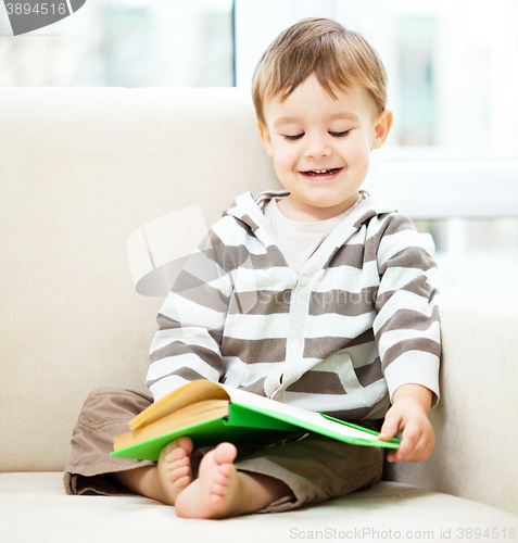 Image of Little boy is reading book