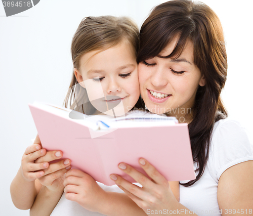 Image of Mother is reading book with her daughter