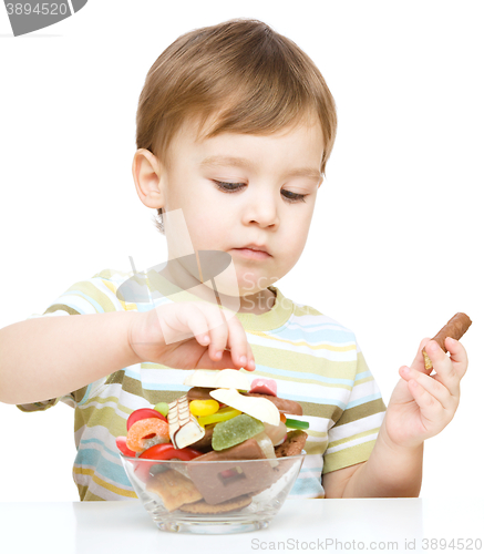 Image of Portrait of a boy with candies