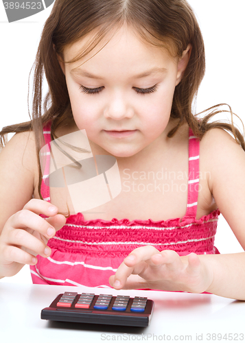 Image of Little girl is using calculator