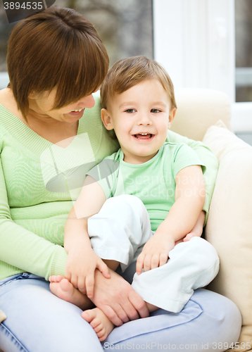 Image of Mother and her son are watching tv