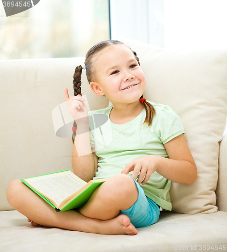 Image of Little girl reads a book