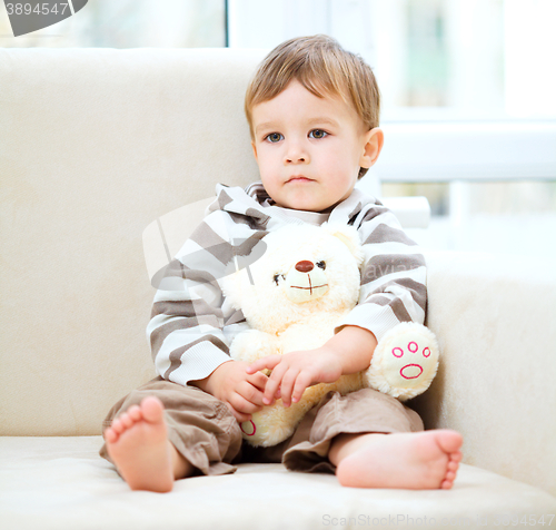 Image of Portrait of a little boy with his teddy bear