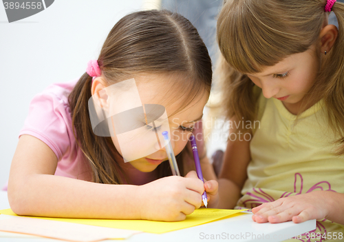 Image of Little girls are writing using a pen