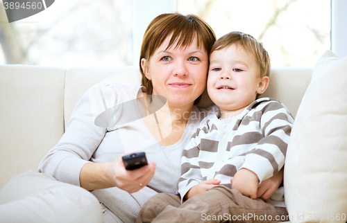 Image of Mother and her son are watching tv