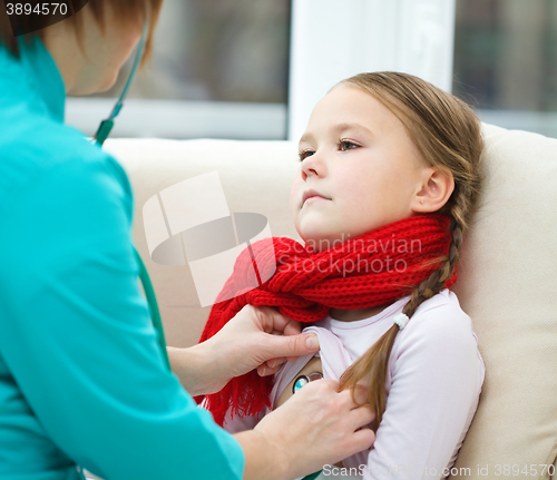 Image of Doctor is examining little girl using stethoscope