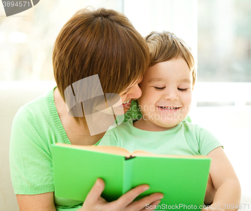 Image of Mother is reading book for her son