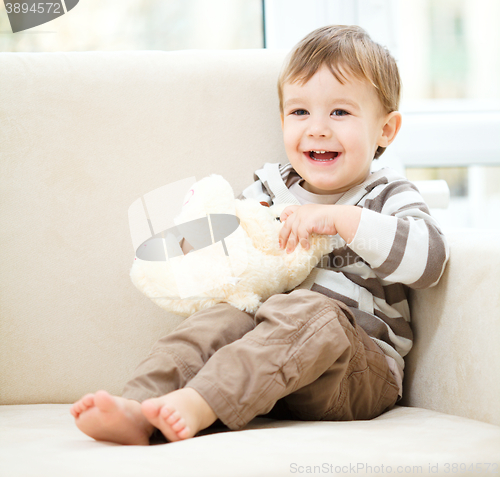 Image of Portrait of a little boy with his teddy bear