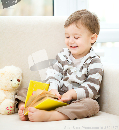 Image of Little boy is reading book