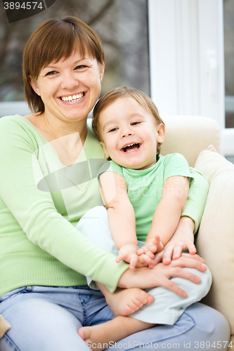 Image of Mother and her son are watching tv