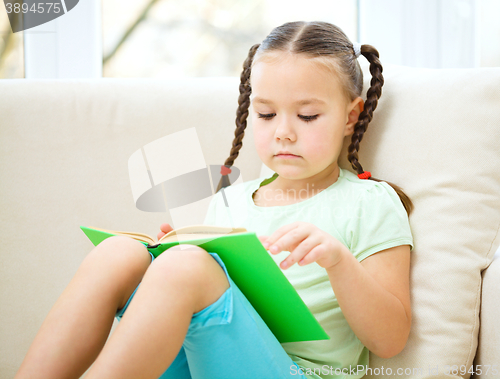 Image of Little girl reads a book